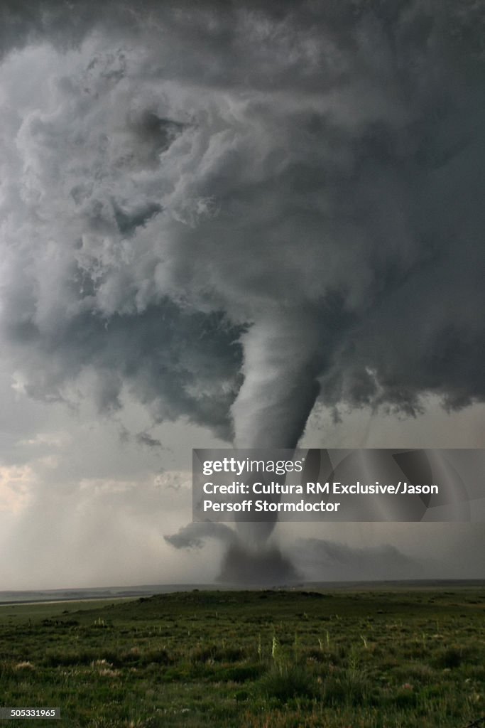 Intense rotation through the """"Barber Poling"""" of bands spiraling up the tornado. At the base there is evidence of horizontal swirls and multiple vortices in the main circulation, Campo, Colorado, USA