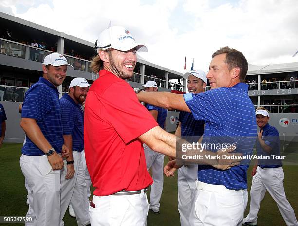 Team Asia caddy gets a friendly ribbing from Team Europe players after winning during day three of the EurAsia Cup presented by DRB-HICOM at...