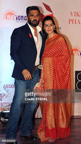 Indian Bollywood actor Suniel Shetty and his wife pose for a photograph during the Vikram Phadnis fashion show in Mumbai on late January 16, 2016....