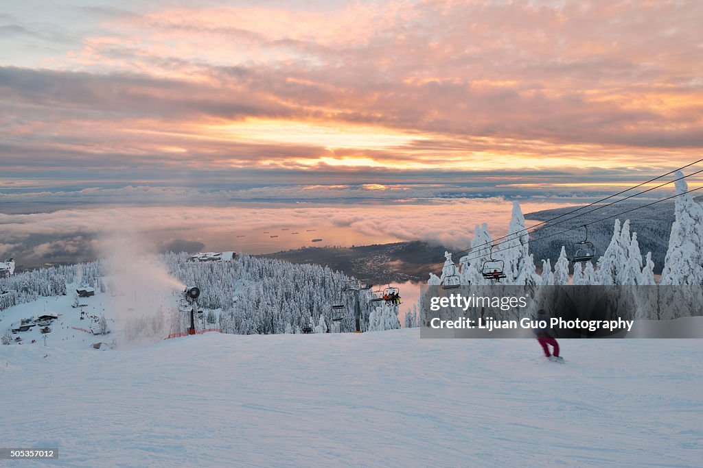 Grouse Mountain Ski Hill with foggy cityscape beneath at sunset