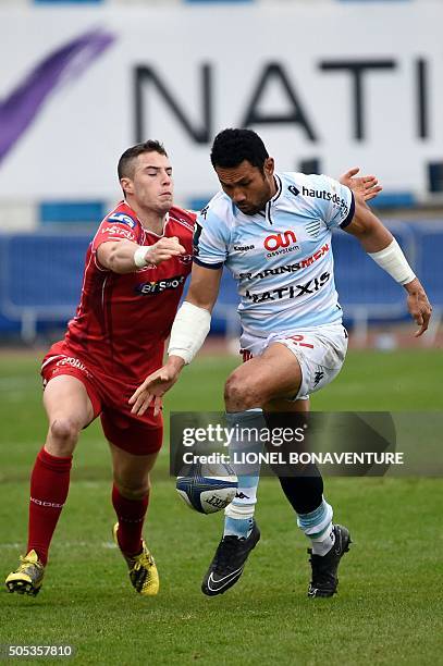 Racing Metro 92 center Casey Laulala vies with Llanelli's fly-half Steve Shingler during the European Rugby Champions Cup match beetween Racing Metro...