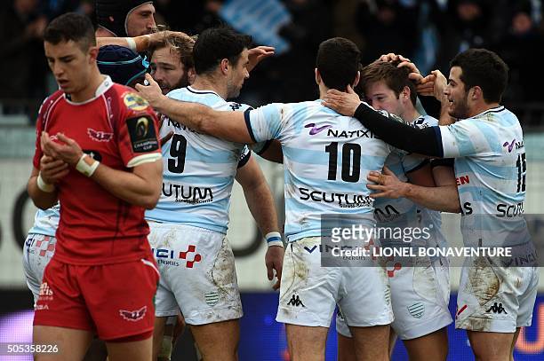 Racing Metro 92 Argentine wing Juan Imhoff is congratulated by teammates after scoring a try during the European Rugby Champions Cup match beetween...