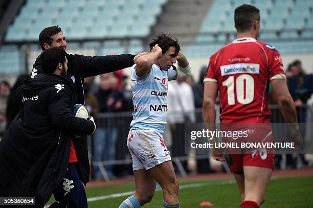 Racing Metro 92's Argentinian wing Juan Imhoff is congratulated by teammates after he scores a try during the European Champions Cup rugby union...