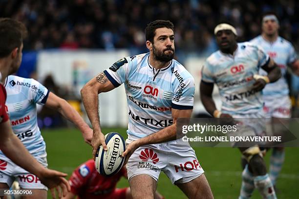 Racing Metro 92's French fly-half Remi Tales passes the ball during the European Champions Cup rugby union match between Racing Metro 92 and Llanelli...