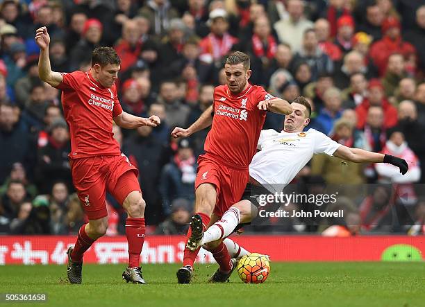 Jordan Henderson of Liverpool competes with Morgan Schneiderlin of Manchester United during the Barclays Premier League match between Liverpool and...