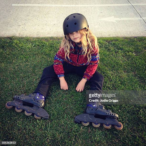 child taking a break from riding in-line skates - all that skate 2014 stock pictures, royalty-free photos & images