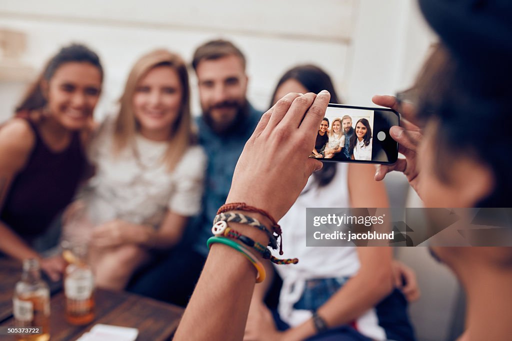 Man photographing his friends at party