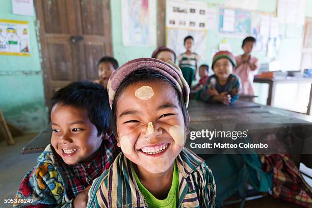 smiling children at local primary school - zuidoost aziatische etniciteit stockfoto's en -beelden