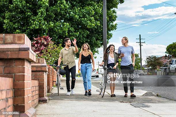 australian friends walking in the street on a sunny day - pedestrian stock pictures, royalty-free photos & images