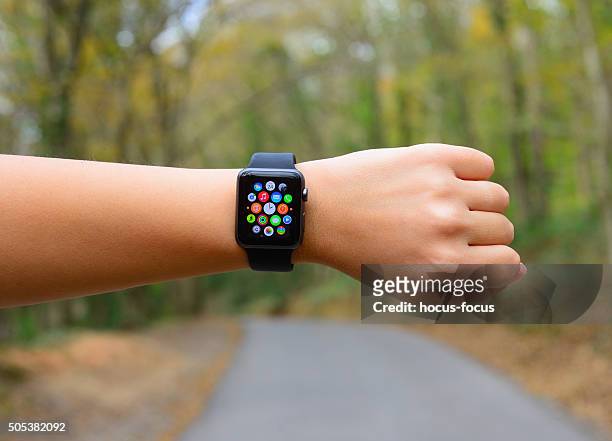 using apple watch sport in park - apple watch stock pictures, royalty-free photos & images