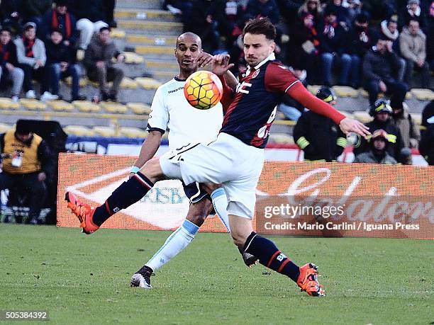 Abdoulay Konko 29 of SS Lazio L kicks the ball oast Matteo Brighi 33 of Bologna FC during the Serie A match between Bologna FC and SS Lazio at Stadio...