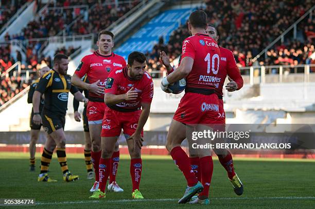 Toulon's Australian fly-half Quade Cooper is congratulated after scoring a goal during the European Champions Cup rugby union match RC Toulon vs...