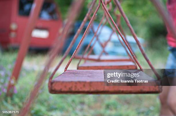 empty rusty swings - kataraktis village stock pictures, royalty-free photos & images