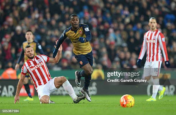 Erik Pieters of Stoke City tackles Joel Campbell of Arsenal during the Barclays Premier League match between Stoke City and Arsenal at Britannia...