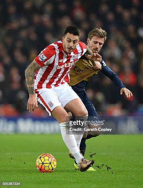 Joselu of Stoke City is closed down by Nacho Monreal of Arsenal during the Barclays Premier League match between Stoke City and Arsenal at Britannia...
