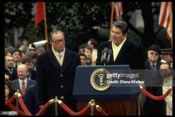 President Ronald Reagan and Chinese Premier Zhao Ziyang standing at podium outside at the White House.