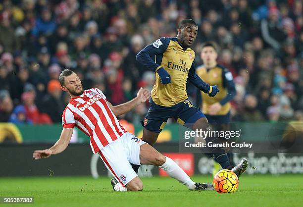 Erik Pieters of Stoke City tackles Joel Campbell of Arsenal during the Barclays Premier League match between Stoke City and Arsenal at Britannia...