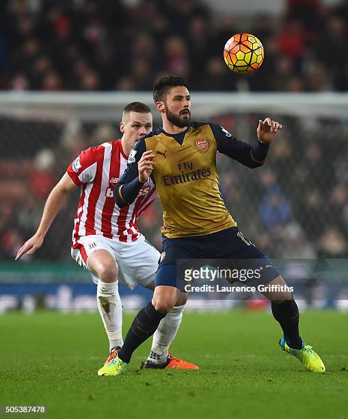 Olivier Giroud of Arsenal is closed down by Ryan Shawcross of Stoke City during the Barclays Premier League match between Stoke City and Arsenal at...