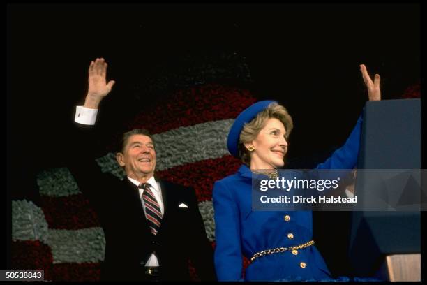 President Ronald Reagan and wife Nancy waving at post-inaugural gathering of marching bands at the Capitol Center.