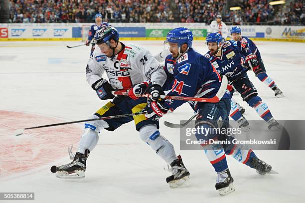 Andre Rankel of Eisbaeren Berlin is challenged by Christopher Fischer of Adler Mannheim during the Ice Hockey DEL match between Adler Mannheim and...