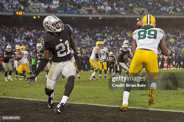 Wide receiver James Jones of the Green Bay Packers collects a touchdown pass against cornerback Dexter McDonald of the Oakland Raiders only to have...