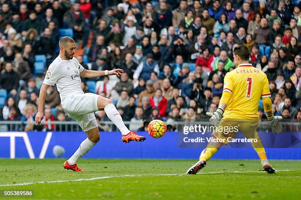 Karim Benzema of Real Madrid scores his team's fifth goal during the La Liga match between Real Madrid CF and Sporting de Gijon at Estadio Santiago...