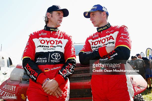Dirk Von Zitzewitz of Germany and Leeroy Poulter of South Africa for TOYOTA HILUX RACING spean at the end of stage thirteen between Villa Carlos Paz...