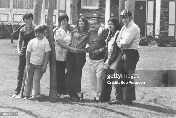 Author Mario Puzo with son Anthony, son Joe, wife Erika, daughter Dorothy, daughter Virginia and son Eugene standing by a tree in the yard of their...