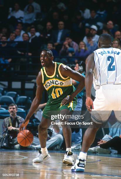 Shawn Kemp of the Seattle Supersonics dribbles the ball against the Charlotte Hornets during an NBA basketball game circa 1993 at the Charlotte...