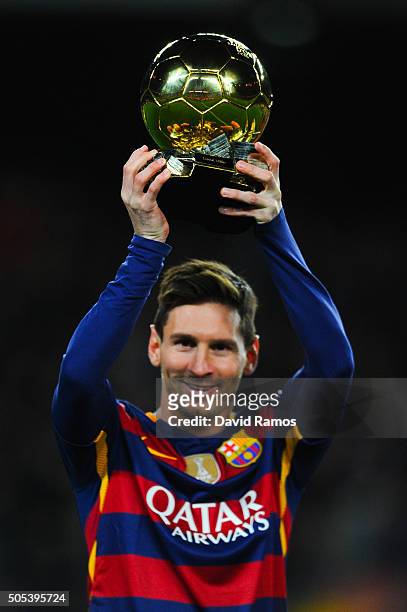 Lionel Messi of FC Barcelona holds up the FIFA Ballon d'Or trophy prior to the La Liga match between FC Barcelona and Athletic Club de Bilbao at Camp...