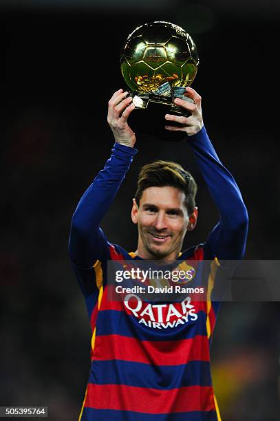 Lionel Messi of FC Barcelona holds up the FIFA Ballon d'Or trophy prior to the La Liga match between FC Barcelona and Athletic Club de Bilbao at Camp...