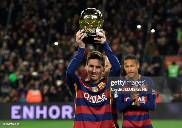 Barcelona's Argentinian forward Lionel Messi poses with his fifth Ballon d'Or trophy before the Spanish league football match FC Barcelona vs...