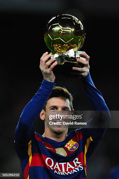 Lionel Messi of FC Barcelona holds up the FIFA Ballon d'Or trophy prior to the La Liga match between FC Barcelona and Athletic Club de Bilbao at Camp...