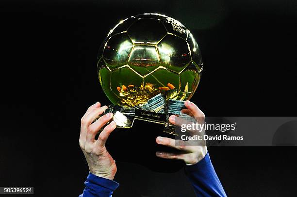 Lionel Messi of FC Barcelona holds up the FIFA Ballon d'Or trophy prior to the La Liga match between FC Barcelona and Athletic Club de Bilbao at Camp...