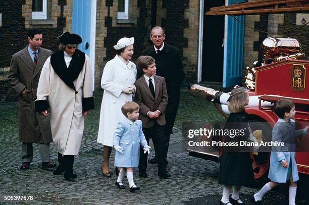 Royal family visit to a museum in Sandringham, where the children climb on a fire engine, January 1988. From left to right Prince Charles, Princess...