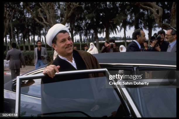 Iranian Parliamentary Pres. Hashemi Rafsanjanni stepping into car as he leaves assembly hall during visit to country