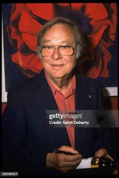 Designer Robert Motherwell signing wine label he created for Chateau Mouton Rothschild.