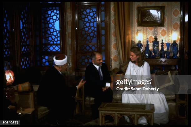 Jordan's King Hussein sitting with bride Lisa Halaby during their wedding ceremony at the royal palace.