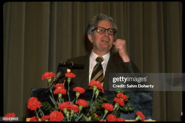 Hans Jochen Vogel, West Germany's Social Democratic Party candidate for Chancellor, giving campaign speech while standing at rose-adorned podium.