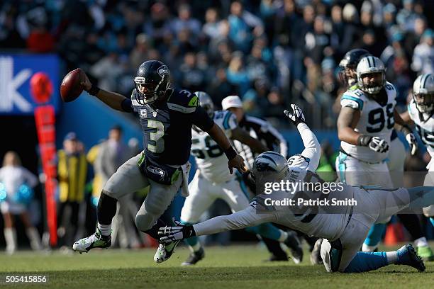 Russell Wilson of the Seattle Seahawks scrambles from Kawann Short of the Carolina Panthers in the 3rd quarter during the NFC Divisional Playoff Game...