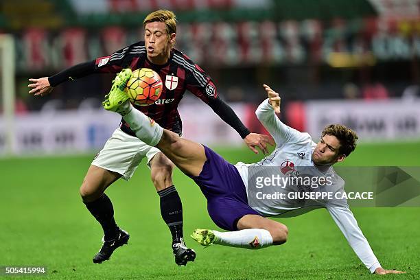 Milan's Japanese midfielder Keisuke Honda vies with Fiorentina's Spanish defender Marcos Alonso Mendoza during the Serie A football match between AC...