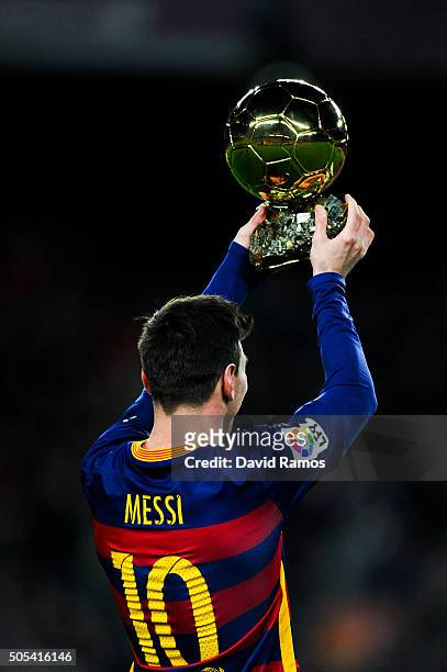 Lionel Messi of FC Barcelona holds up the FIFA Ballon d'Or trophy prior to the La Liga match between FC Barcelona and Athletic Club de Bilbao at Camp...