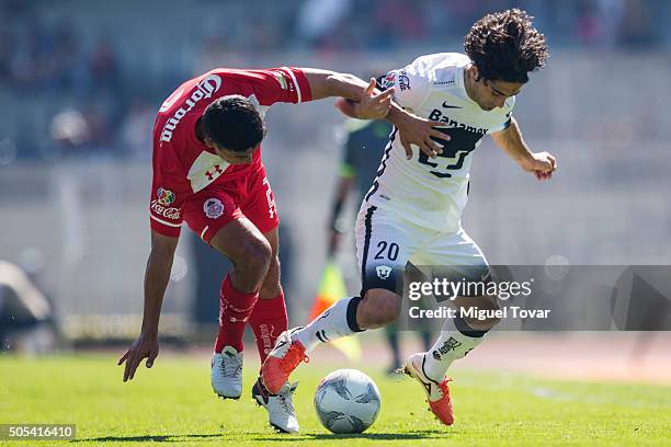 Matias Britos of Pumas fights for the ball with Francisco Gamboa of Toluca during a match between Pumas UNAM and Diablos Toluca as part of second...