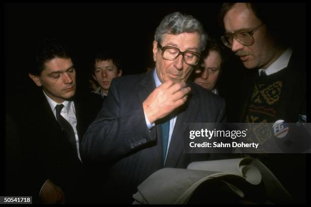 Irish Prime Minister Garret Fitzgerald reading through paperwork while awaiting outcome of election.