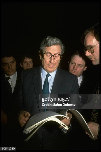 Irish Prime Minister Garret Fitzgerald reading through paperwork while awaiting outcome of election.