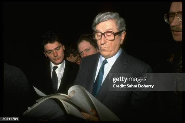 Irish Prime Minister Garret Fitzgerald reading through paperwork while awaiting outcome of election.