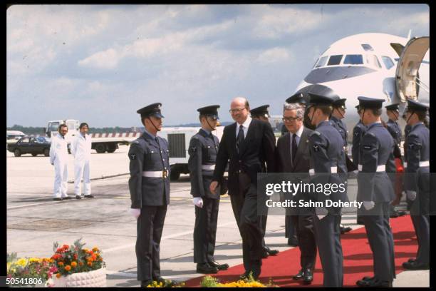 Italian Prime Minister Bettino Craxi being escorted by Foreign Secretary Geoffrey Howe through color guard upon arriving in England for the Economic...