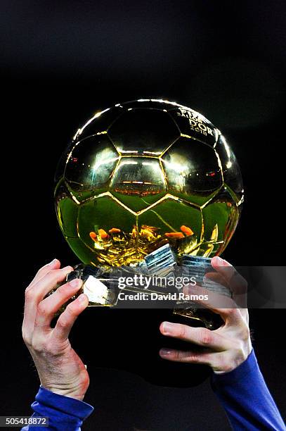 Lionel Messi of FC Barcelona holds up the FIFA Ballon d'Or trophy prior to the La Liga match between FC Barcelona and Athletic Club de Bilbao at Camp...