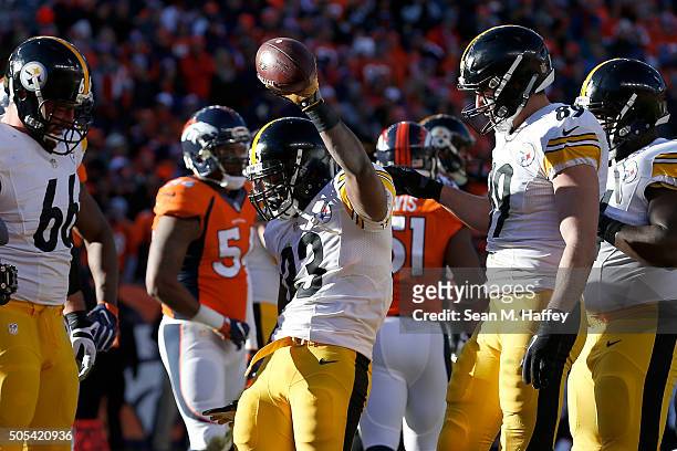 Fitzgerald Toussaint of the Pittsburgh Steelers celebrates after scoring a one yard touchdown in the first quarter against the Denver Broncos during...