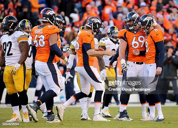 Denver Broncos players, including Aaron Brewer of the Denver Broncos, celebrate with Brandon McManus of the Denver Broncos after he kicked a 51 yard...